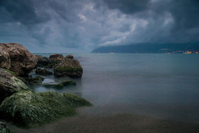 Scenic view of sea against storm clouds