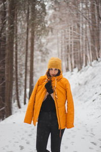 Woman standing on snow covered land