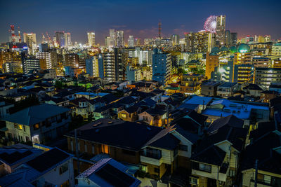 High angle view of illuminated buildings in city at night