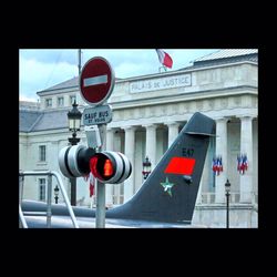 Road sign in front of building