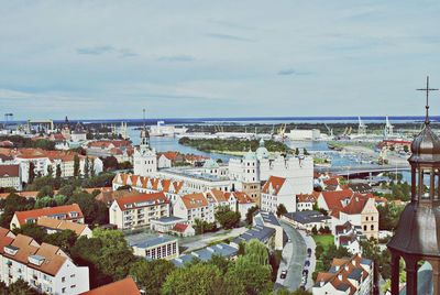 High angle view of cityscape by sea against sky