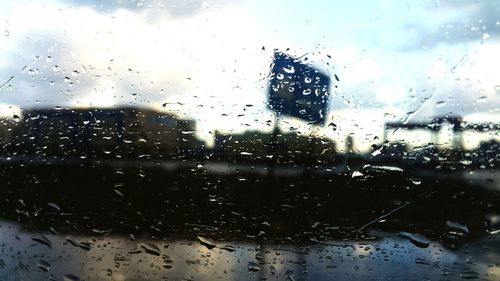 Raindrops on glass window of rainy season