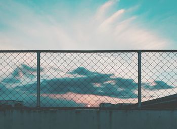 Close-up of chainlink fence against sky