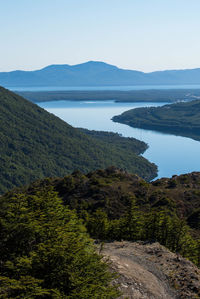 Scenic view of lake and mountains against clear sky