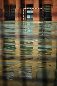 Building reflecting at wet sports court