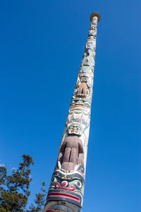 Low angle view of sculpture against blue sky