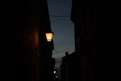 Low angle view of illuminated street light at night