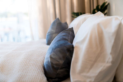 Midsection of man relaxing on bed at home