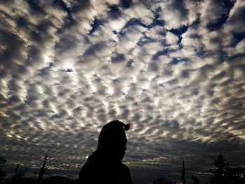 Low angle view of silhouette man against sky