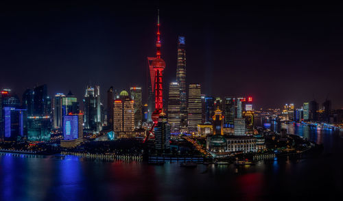 Illuminated buildings against sky at night