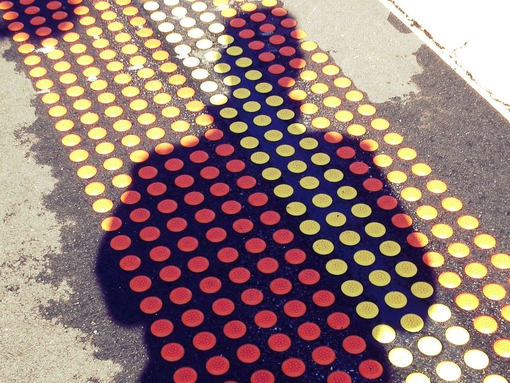 red, high angle view, pattern, architecture, built structure, building exterior, wall - building feature, street, no people, outdoors, day, sunlight, close-up, shadow, multi colored, in a row, still life, textured, geometric shape, paving stone