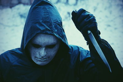 Close-up of man in costume holding knife