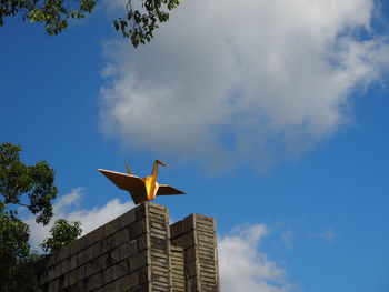 Low angle view of statue against cloudy sky