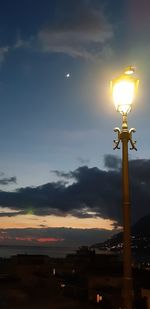 Low angle view of illuminated street light against sky during sunset