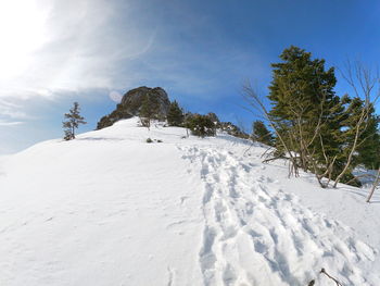 Scenic view of snow covered landscape against sky