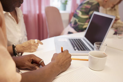 View of coworkers hands during business meeting