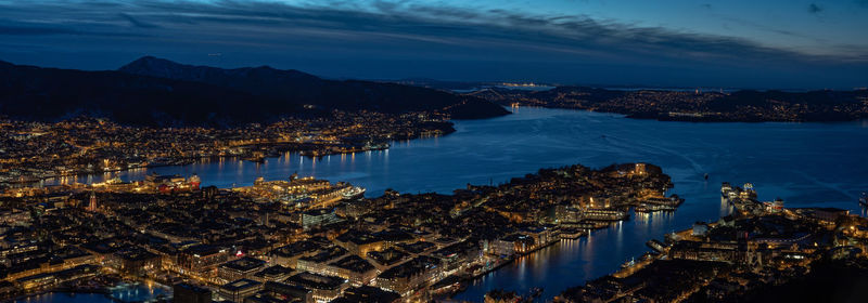 High angle view of city lit up at night