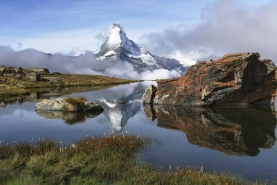 The stellisee lake with a reflection of matterhorn during a morning hike in zermatt, switzerland