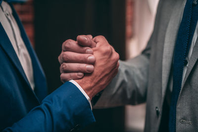 Close-up of hands on cross