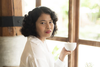Portrait of woman drinking coffee