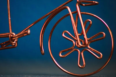 Close up of a wheel made from copper wire 