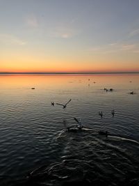 Scenic view of lake against sky during sunset