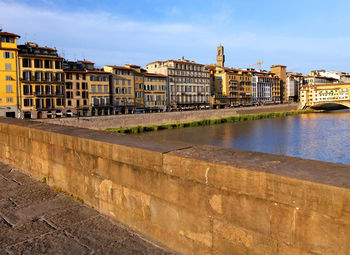 Buildings by arno river seen from ponte santa trinita in tuscany