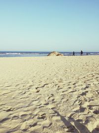 Scenic view of beach against clear sky