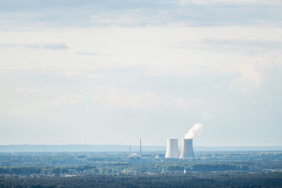 Smoke emitting from chimney against sky