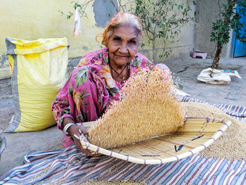 Portrait of woman separating rice