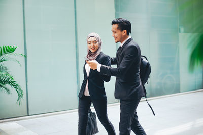 Side view of a young couple standing outdoors