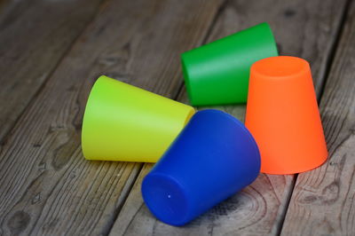 Close-up of multi colored drinking glasses on table