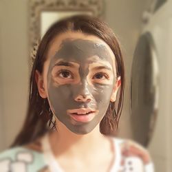 Close-up of girl wearing face mask at home