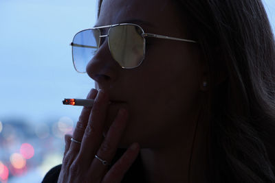 Close-up portrait of woman wearing sunglasses