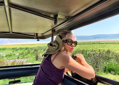 Woman looking through safari car