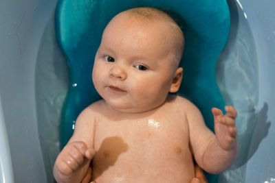 Close-up of cute baby boy in bathtub