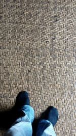 Low section of person standing on tiled floor