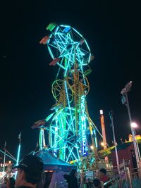 Low angle view of illuminated ferris wheel at night