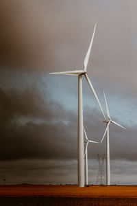 Windmills against sky