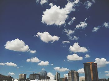 Low angle view of buildings against blue sky