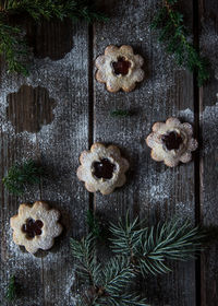 Directly above shot of cookies with pine needles on table