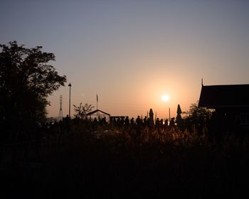 Silhouette plants against clear sky during sunset