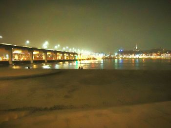 Reflection of illuminated built structure in water