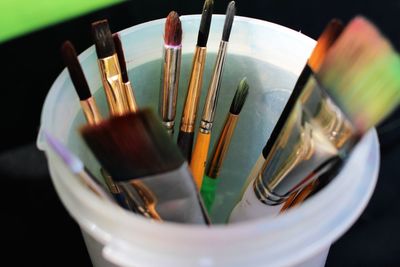 Close-up of paintbrushes in can