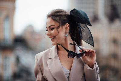 Portrait of a smiling young woman holding outdoors