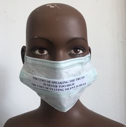 Close-up of mannequin with mask and quotes