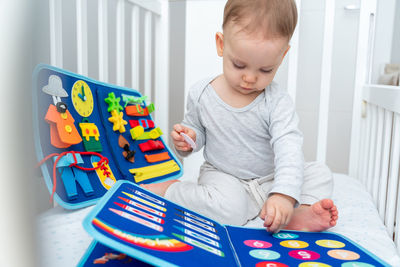 Portrait of boy playing with toy blocks at home