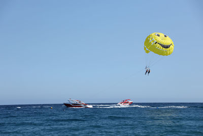 Person paragliding against sky