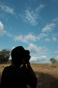 Rear view of silhouette man against sky