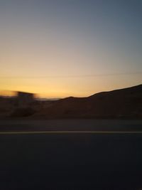 Scenic view of silhouette landscape against clear sky during sunset